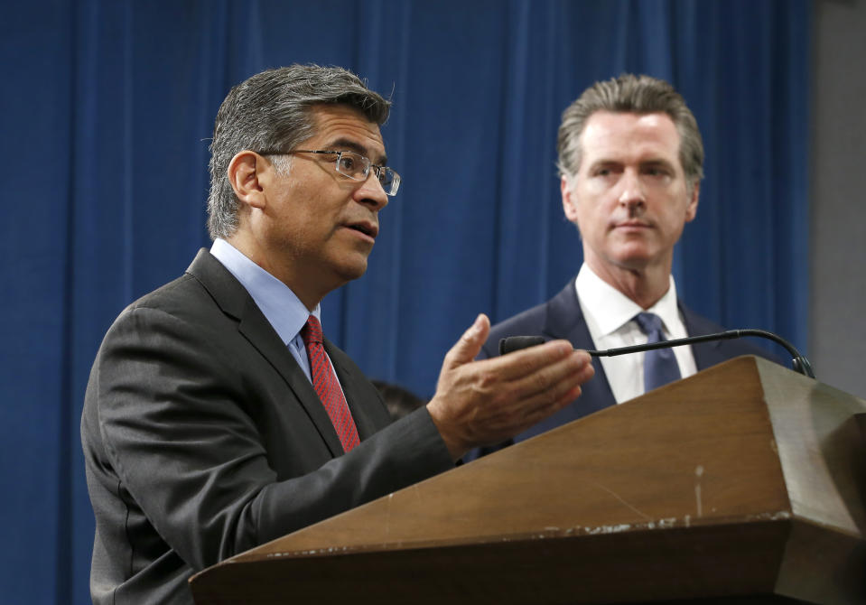 California Attorney General Xavier Becerra, left, flanked by Gov. Gavin Newsom, discusses the lawsuit the state has filed against the Trump administration's new rules blocking green cards for many immigrants who receive government assistance, during a news conference in Sacramento, Calif., Friday, Aug. 16, 2019. California, three other states and the District of Columbia filed the suit Friday against some of the administration's most aggressive moves to restrict legal immigration that are supposed to take effect in October. (AP Photo/Rich Pedroncelli)