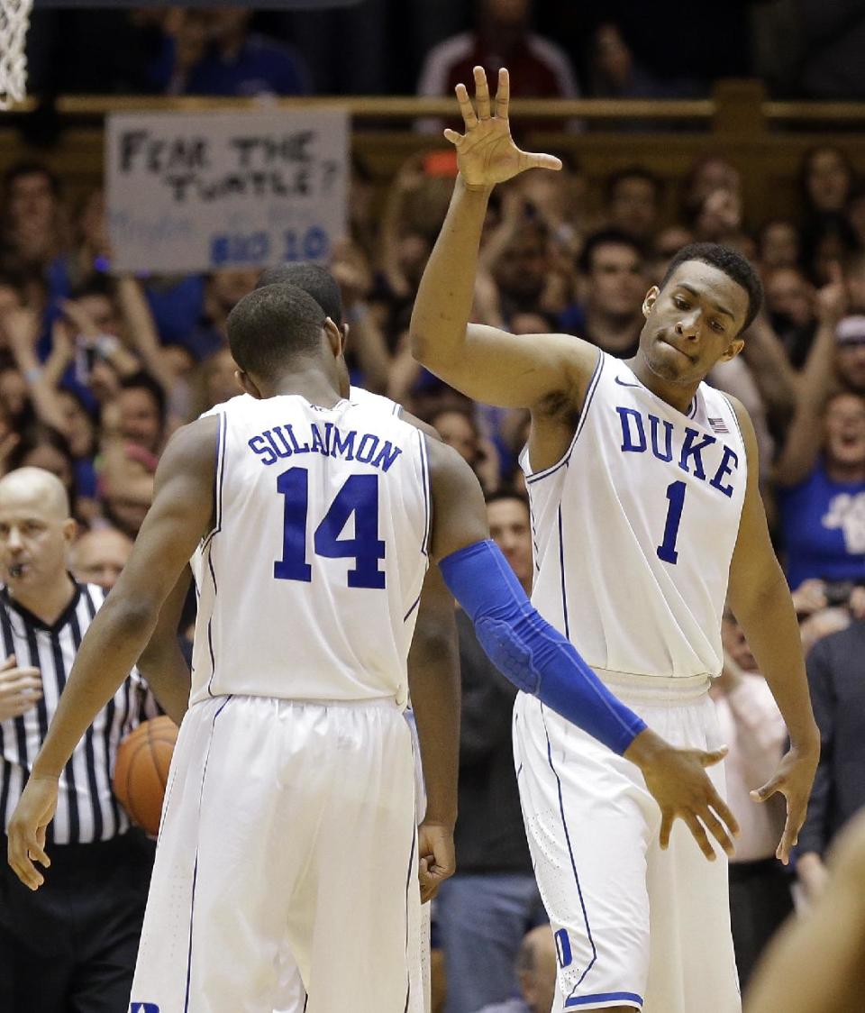 Duke's Jabari Parker (1) and Rasheed Sulaimon (14) react following Parker's basket against Maryland during the second half of an NCAA college basketball game in Durham, N.C., Saturday, Feb. 15, 2014. Duke won 69-67. (AP Photo/Gerry Broome)