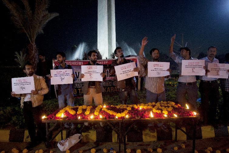 People attend a candlelight vigil for the victims of Monday's suicide bombing in Lahore, Tuesday, Feb. 14, 2017 in Karachi, Pakistan. Pakistan's cultural capital of Lahore on Tuesday mourned the victims of a suicide bombing the previous day that killed 13 people. Markets and businesses remained closed across much of the country's eastern Punjab province while flags at government buildings are at half-staff. (AP Photo/Shakil Adil)