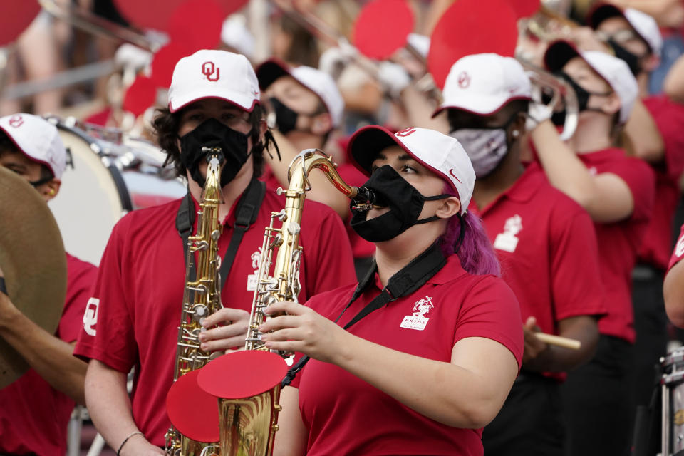 FILE - In this Saturday, Sept. 12, 2020 file photo, a reduced size Oklahoma band performs in the stands in the second half of an NCAA college football game against Missouri State in Norman, Okla. Marching bands, part of the game since its beginning more than a century ago, are idled or toned down across the country. They won’t be able to perform in front of the usual crowds at football games, dramatically changing the experience. (AP Photo/Sue Ogrocki, File)