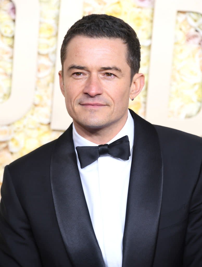 Orlando Bloom in a classic black tuxedo with a bow tie