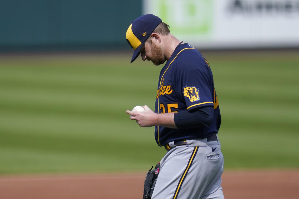 Milwaukee Brewers starting pitcher Brett Anderson looks down at his hand as he walks off the field while leaving with an injury during the third inning of a baseball game against the St. Louis Cardinals Sunday, Sept. 27, 2020, in St. Louis. (AP Photo/Jeff Roberson)