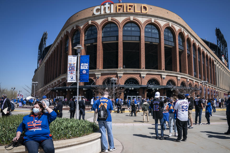 Fans arrive for COVID-19 screenings before entering Citifield before New York Mets home opening baseball game against the Miami Marlins, Thursday, April 8, 2021, in New York. (AP Photo/John Minchillo)