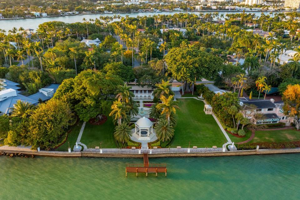 a waterfront property surrounded by lush green trees in Florida