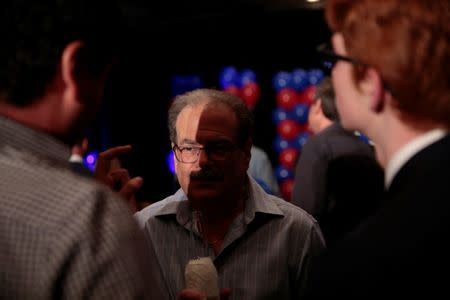 Leonard Jacobs (C) talks politics with his son Steven Jacobs (L) and Harrison Darby, 16, at Democrat Jon Ossoff's election night event in Atlanta, Georgia, U.S., June 20, 2017. REUTERS/Chris Aluka Berry