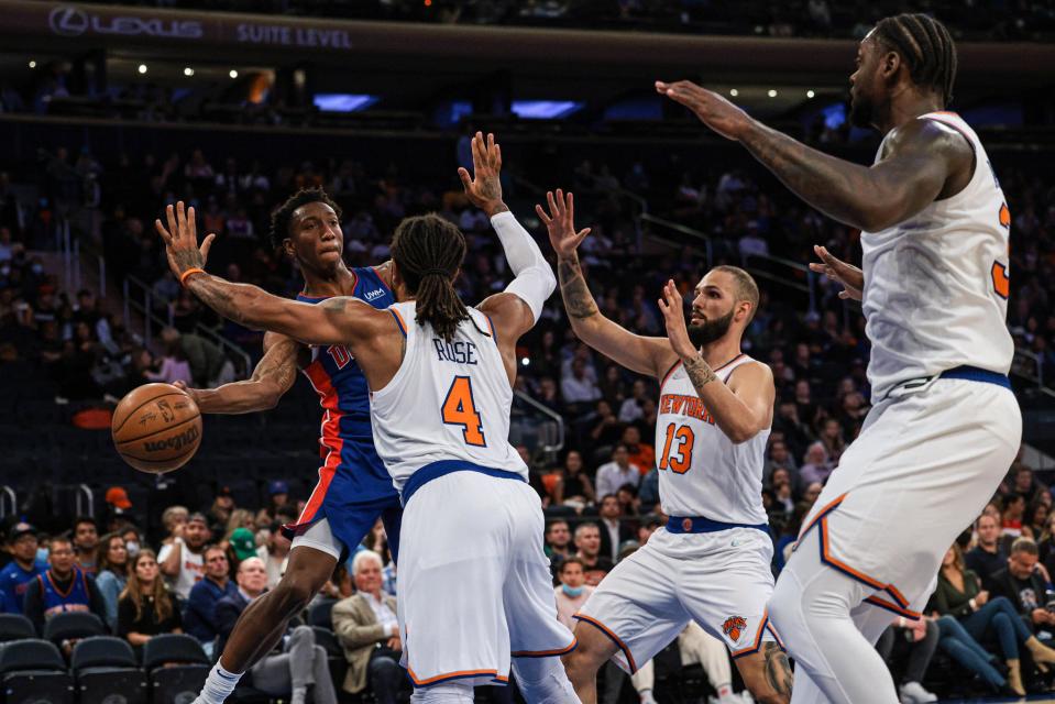 Detroit Pistons guard Saben Lee passes the ball around New York Knicks guard Derrick Rose during the first half at Madison Square Garden.