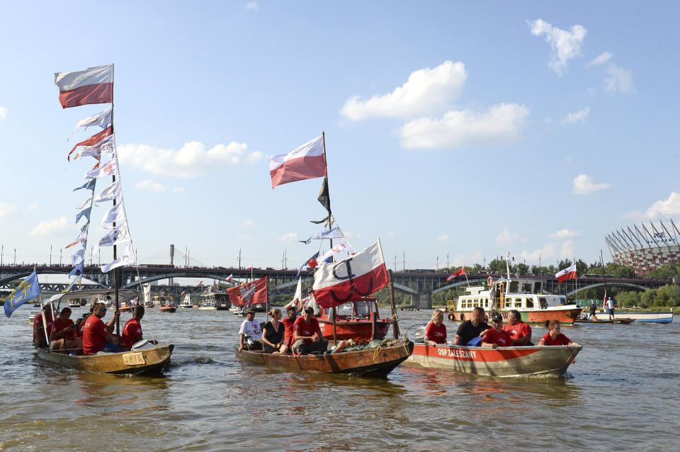 People in boats take part in a parade on the Vistula river to mark the 74th anniversary of the 1944 Warsaw Rising against the Nazi German occupiers, in Warsaw, Poland, Wednesday, Aug. 1, 2018. (AP Photo/Alik Keplicz)