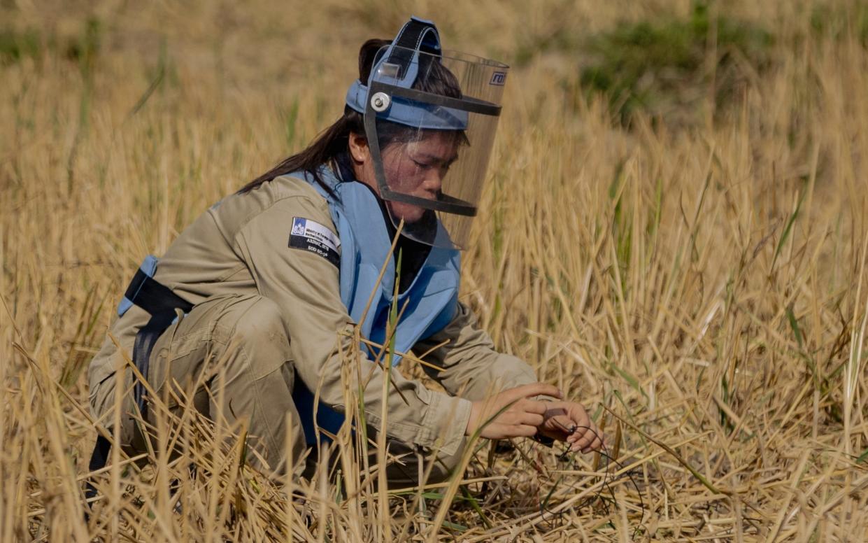 A technician prepares for a controlled explosion