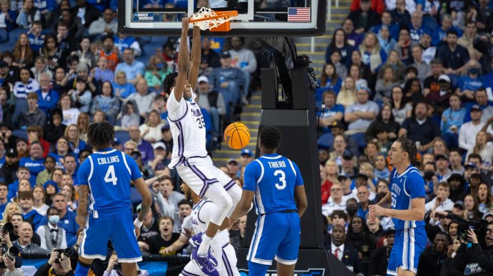 Kansas State’s Nae’Qwan Tomlin throws down an alley-oop dunk just before halftime against Kentucky during the first half of their second round NCAA Tournament game in Greensboro, NC on Sunday.