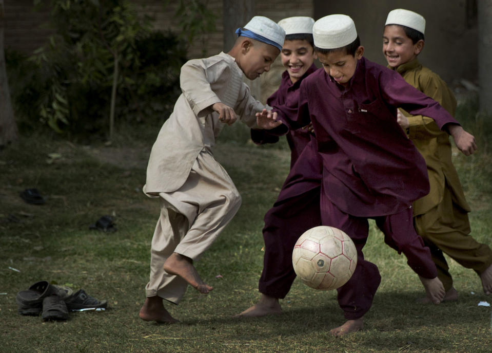 FILE - Boys play soccer during a break at their school in Kandahar, southern Afghanistan, Tuesday, Oct 29, 2013. (AP Photo/Anja Niedringhaus, File)