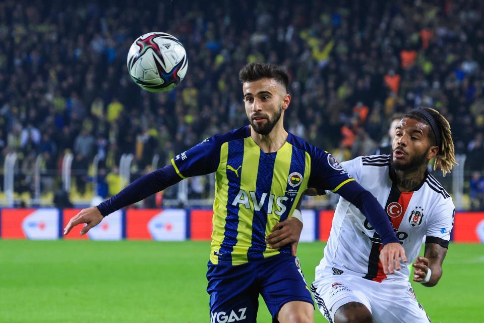 Fenerbahce's Diego Rossi, left, battles for the ball with Besiktas' Valentin Rosier during the Turkish Super League soccer match between Fenerbahce and Besiktas at the Sukru Saracoglu stadium, in Istanbul, Turkey, Sunday, Dec. 19, 2021. (AP Photo)