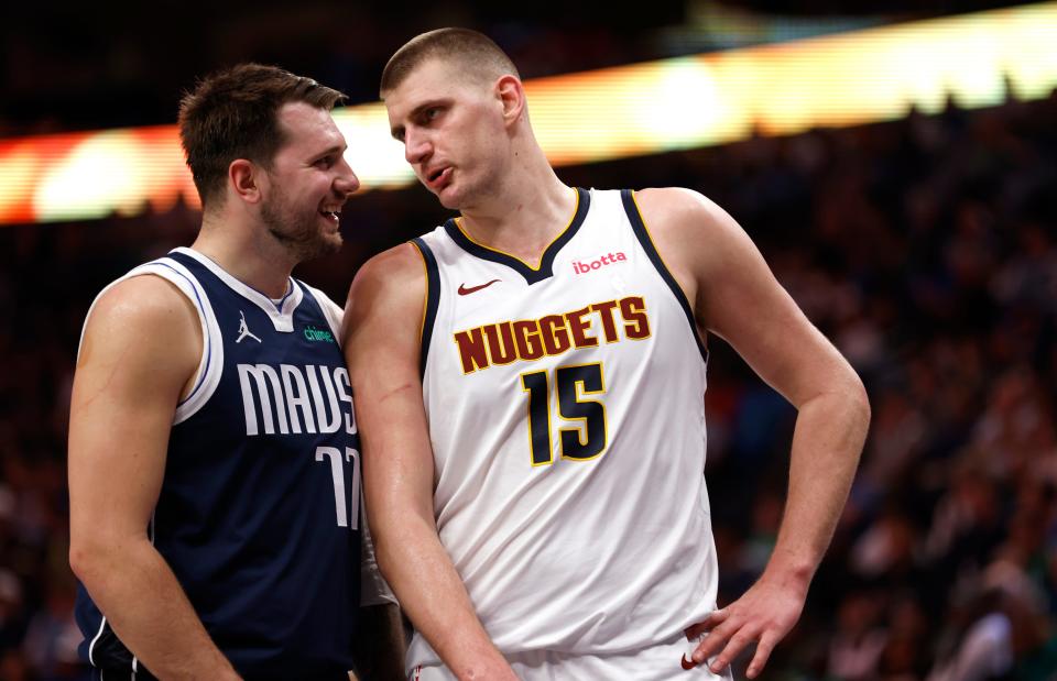 DALLAS, TX - MARCH 17: Luka Doncic #77 of the Dallas Mavericks and Nikola Jokic #15 of the Denver Nuggets talk during a beak in the action in the second half at American Airlines Center on March 17, 2024 in Dallas, Texas. NOTE TO USER: User expressly acknowledges and agrees that, by downloading and or using this photograph, User is consenting to the terms and conditions of the Getty Images License Agreement. (Photo by Ron Jenkins/Getty Images)