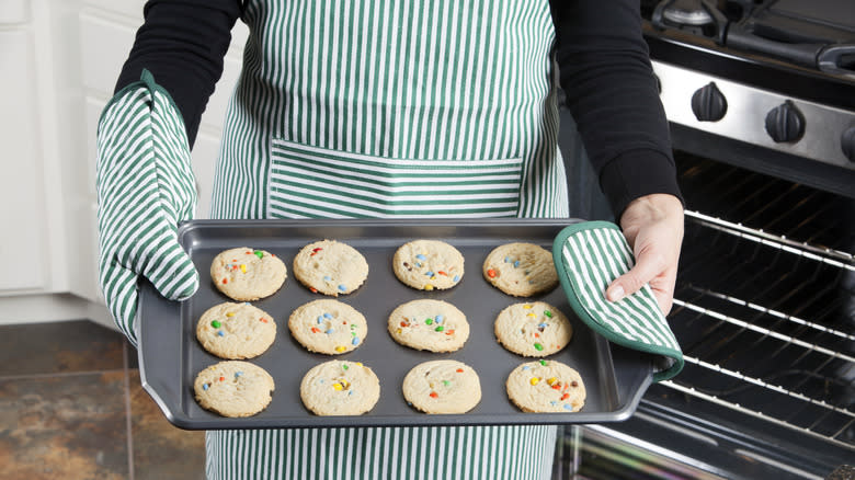 Holding baking sheet with cookies