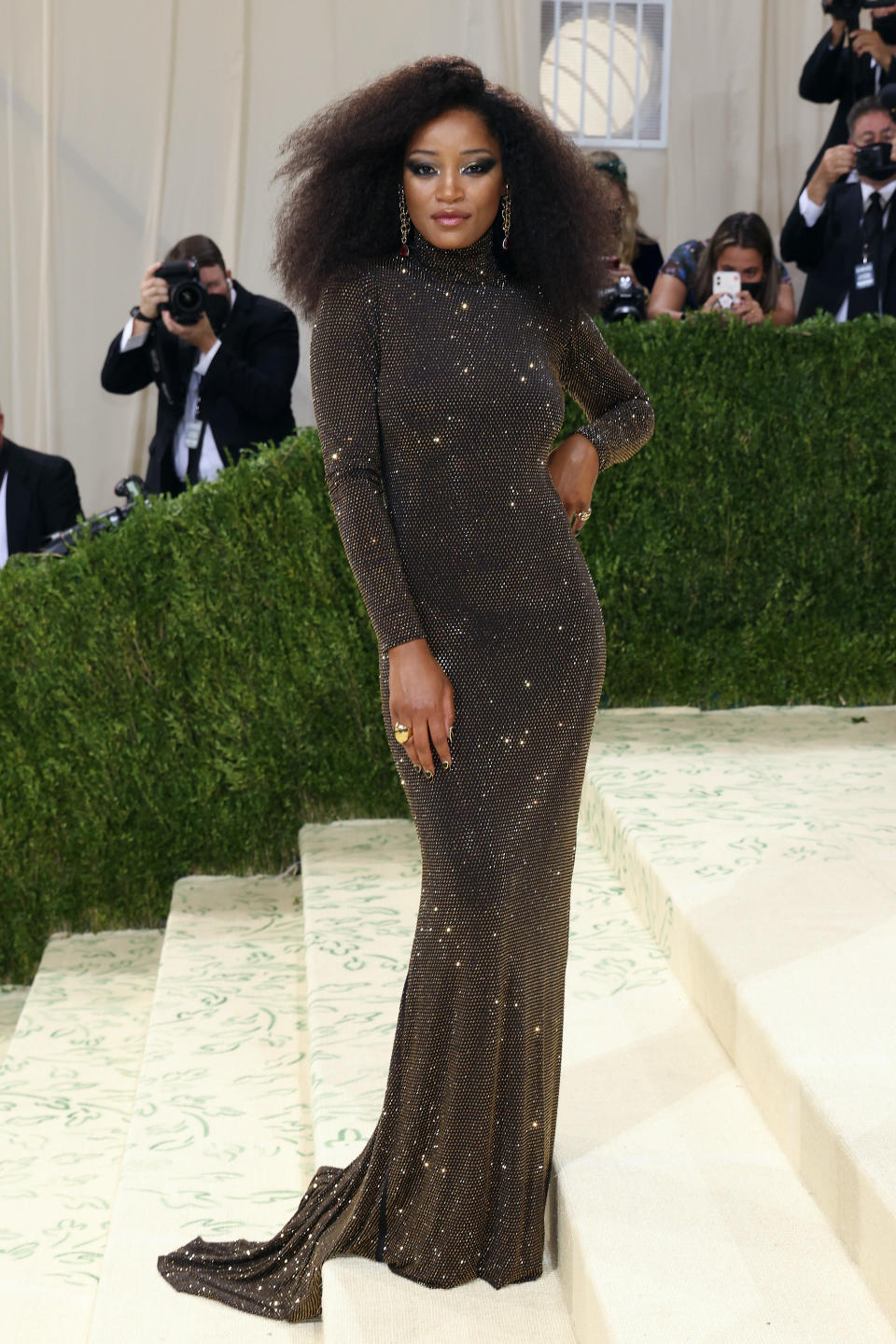 Keke in a shimmering floor-length gown on the red carpet