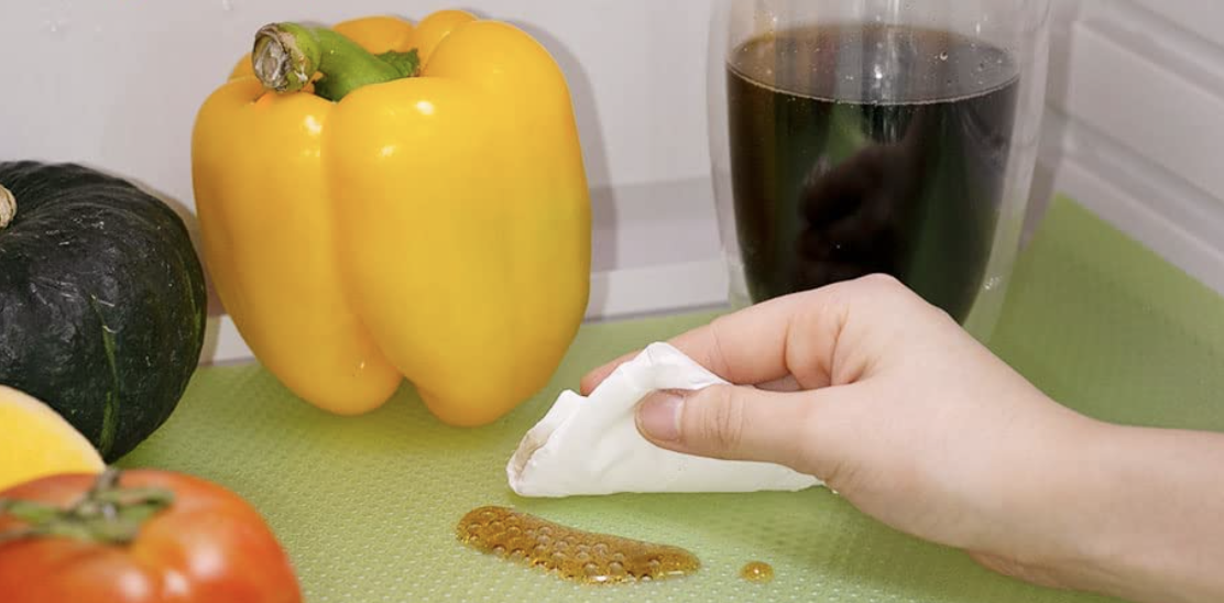 person cleaning fridge spill