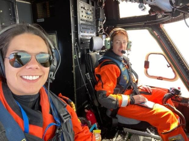 Allison Rumbolt sits next to first officer Zoe Webb aboard Cougar Helicopters' first flight with an all-female crew. (Submitted by Allison Rumbolt - image credit)