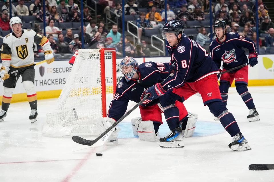 Mar 4, 2024; Columbus, Ohio, USA; Columbus Blue Jackets defenseman Zach Werenski (8) moves the puck away from goaltender Daniil Tarasov (40) during the second period of the NHL hockey game against the Vegas Golden Knights at Nationwide Arena.