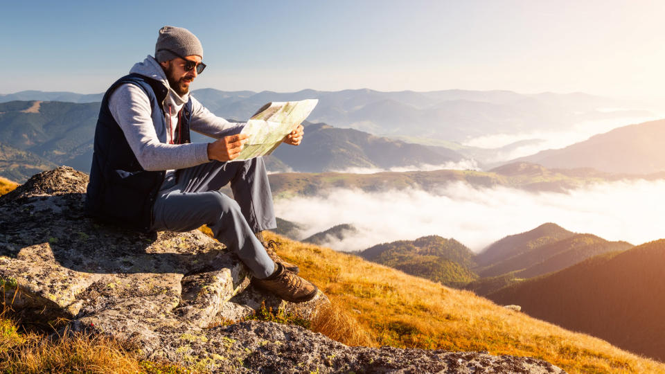 how to orientate a map: hiker looking at map
