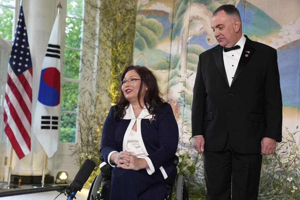 Sen. Tammy Duckworth, D-Ill., and Bryan Bowlsbey arrive for the State Dinner with President Joe Biden and the South Korea's President Yoon Suk Yeol at the White House, Wednesday, April 26, 2023, in Washington. (AP Photo/Alex Brandon)