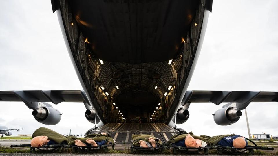 Medical training dummies wait at the bottom of the ramp of a Royal Australian Air Force C-17 Globemaster III July 10 during Exercise Mobility Guardian 23 on Andersen Air Force Base, Guam. (Staff Sgt. Devin Rumbaugh/Air Force)