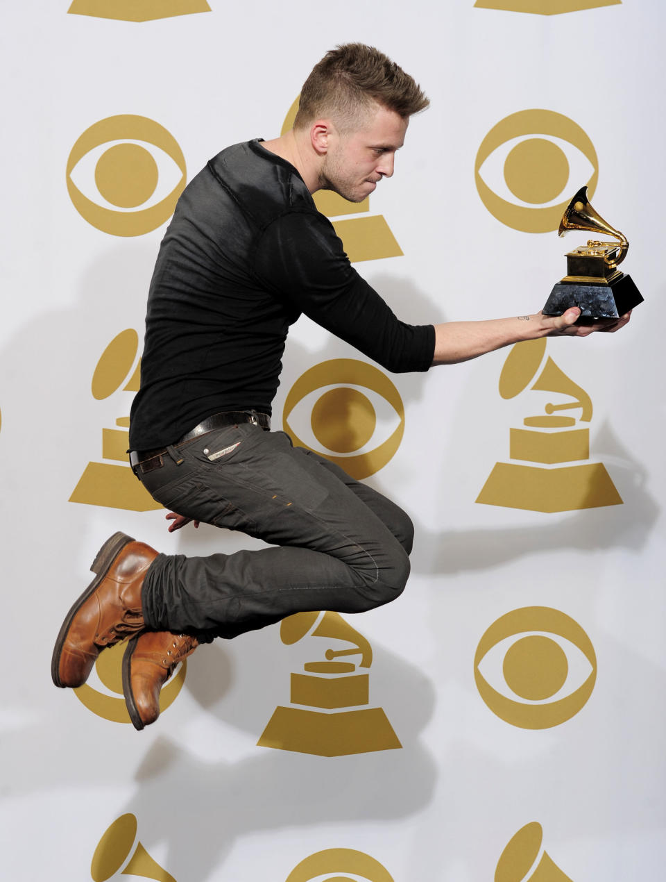 FILE - In this Feb. 12, 2012 file photo, Ryan Tedder poses backstage with the award for album of the year for "21" at the 54th annual Grammy Awards in Los Angeles. The 33-year-old OneRepublic singer and songwriter says his favorite shirts are the ones he bought when was a teenager, and they're from thrift shops. (AP Photo/Mark J. Terrill, File)