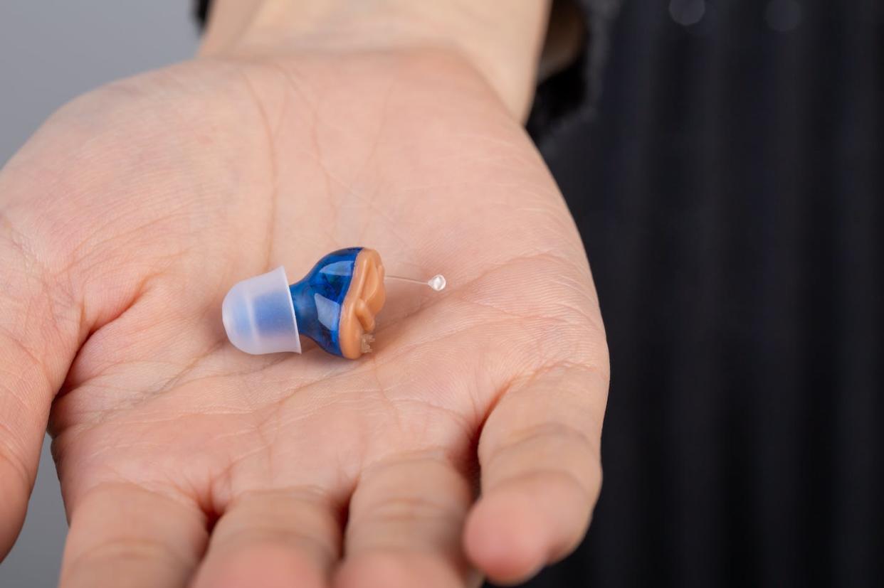 The FDA Reauthorization Act of 2017 designated a new class of OTC hearing aids. <a href="https://www.gettyimages.com/detail/photo/close-up-of-hearing-aid-on-woman-palm-royalty-free-image/1286134759" rel="nofollow noopener" target="_blank" data-ylk="slk:Heizeng Hu/Moment via Getty Images;elm:context_link;itc:0;sec:content-canvas" class="link ">Heizeng Hu/Moment via Getty Images</a>