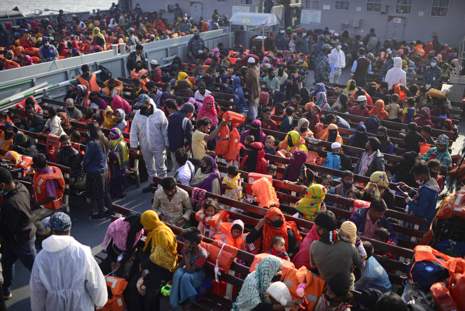 Rohingya refugees wait in a naval ship to be transported to an isolated island in the Bay of Bengal, in Chittagong, Bangladesh, Tuesday, Dec. 29, 2020. Officials in Bangladesh sent a second group of Rohingya refugees to the island on Monday despite calls by human rights groups for a halt to the process. The Prime Minister’s Office said in a statement that more than 1,500 Rohingya refugees left Cox’s Bazar voluntarily under government management. Authorities say the refugees were selected for relocation based on their willingness, and that no pressure was applied on them. But several human rights and activist groups say some refugees have been forced to go to the island, located 21 miles (34 kilometers) from the mainland. (AP Photo/Mahmud Hossain Opu)