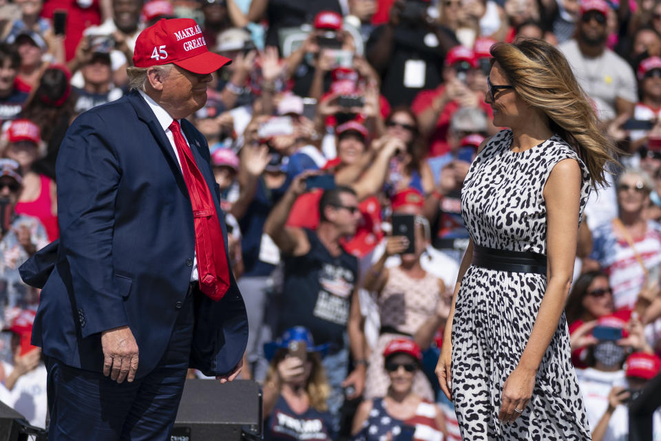 President Donald Trump smiles at first lady Melania Trump after she introduced him at a campaign rally outside Raymond James Stadium, Thursday, Oct. 29, 2020, in Tampa. (AP Photo/Evan Vucci)