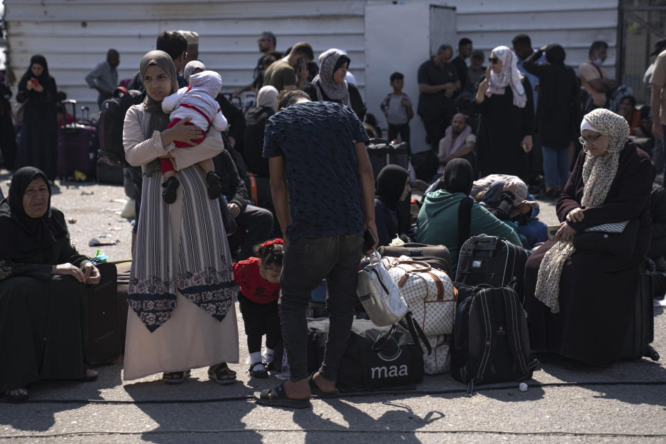 Palestinians wait to cross into Egypt at the Rafah border crossing in the Gaza Strip on Monday, Oct.16, 2023. (AP Photo/Fatima Shbair)