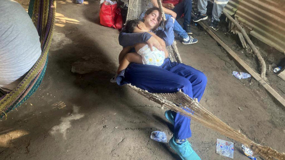 This photo, courtesy of Melanie Rolo Gonzalez, shows her daughter, Madisson, held by her sister Merlyn, shortly before they crossed a river on the Guatemala-Mexico border, early Saturday, Dec. 17, 2022. The child and two women were winding their way through Central America to reach the U.S., part of a historic wave of Cuban migration. (Melanie Rolo Gonzalez via AP)