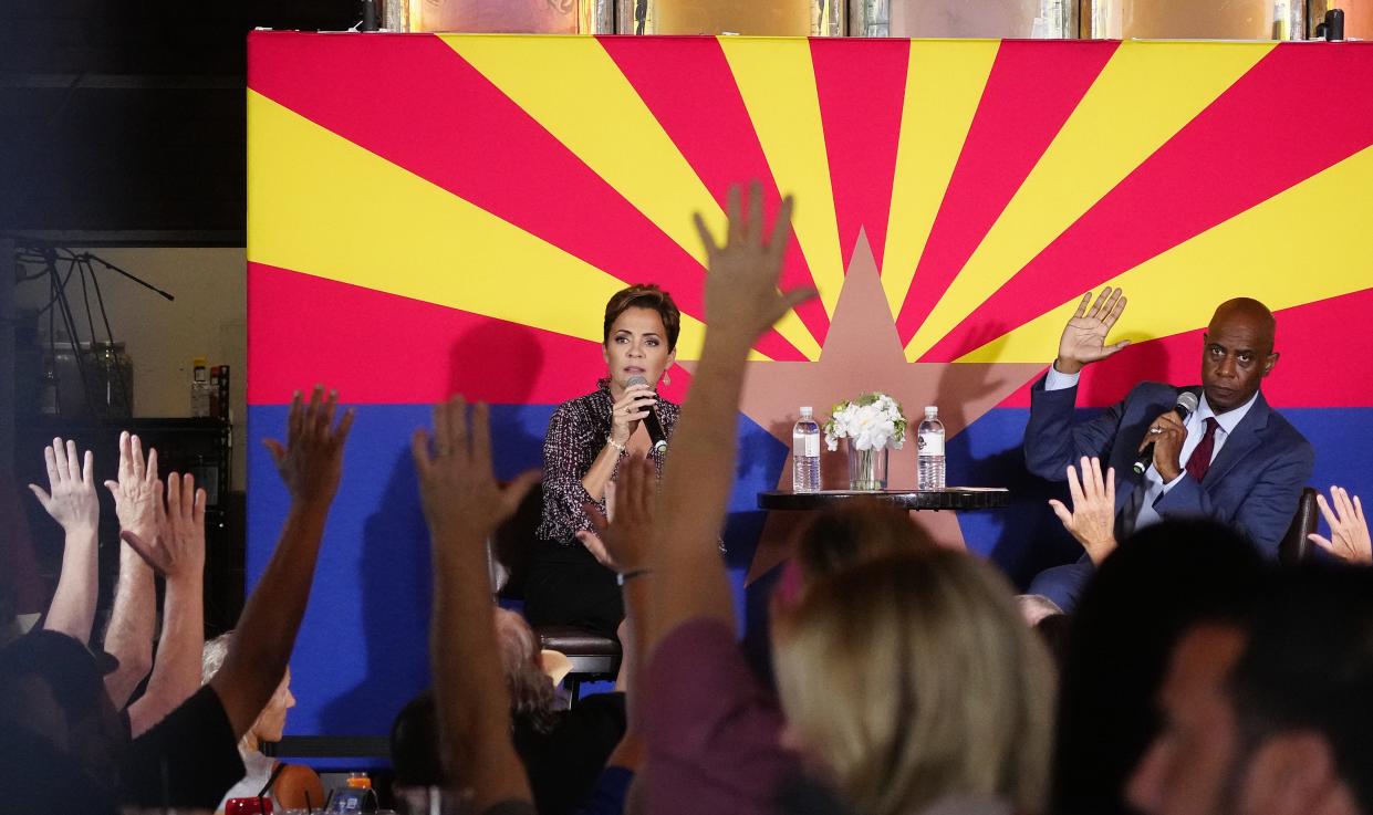 The crowd raises hands after a question from Republican gubernatorial nominee Kari Lake during her campaign event at Social Tap in Scottsdale on Nov. 2, 2022.