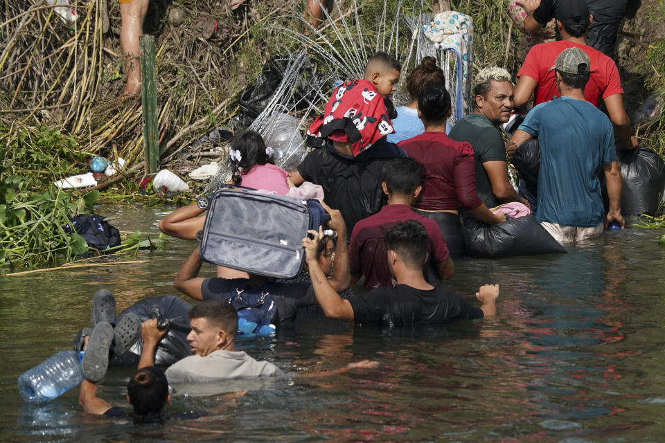 FILE - Venezuelan migrant Luis Parra, third right, joins other migrants crossing the Rio Grande river, seen from Matamoros, Mexico, May 10, 2023. Parra and his niece Leidy Arriza arrived at the border after staying overnight in the Mexican city of Monterrey. (AP Photo/Fernando Llano, File)