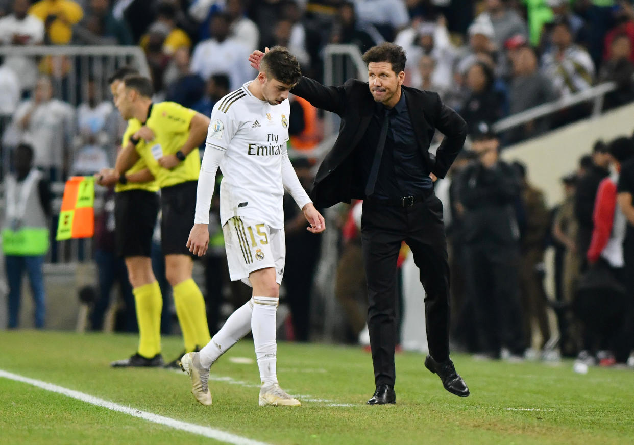 Soccer Football - Spanish Super Cup Final - Real Madrid v Atletico Madrid - King Abdullah Sports City, Jeddah, Saudi Arabia - January 12, 2020   Atletico Madrid coach Diego Simeone with Real Madrid's Federico Valverde who leaves the pitch after being shown a red card by the referee    REUTERS/Waleed Ali