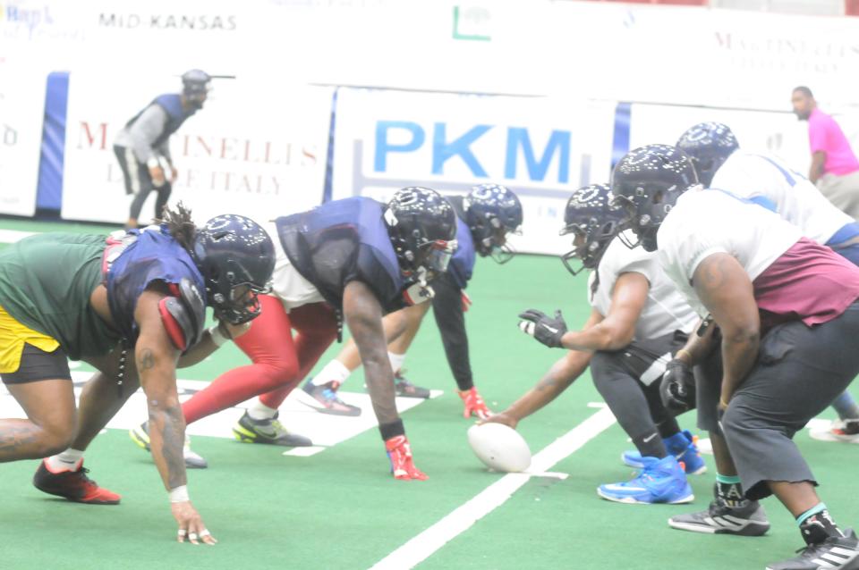 The Salina Liberty defensive line, in blue, goes against the offensive line during practice Thursday at Tony's Pizza Events Center.