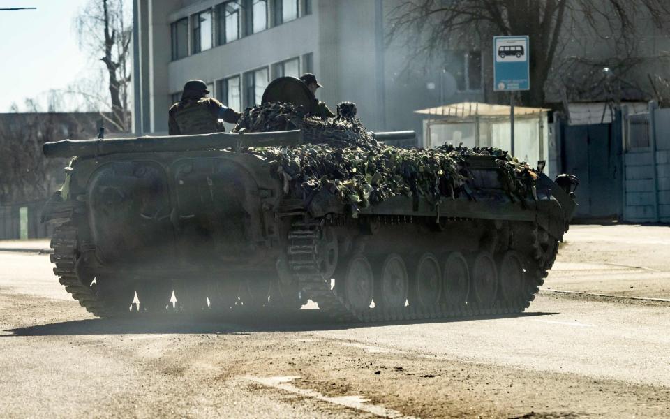 A Ukrainian military tank is seen on a road in Kyiv. Russians reinforce their positions around the capital which has not yet been fully surrounded - FADEL SENNA/AFP