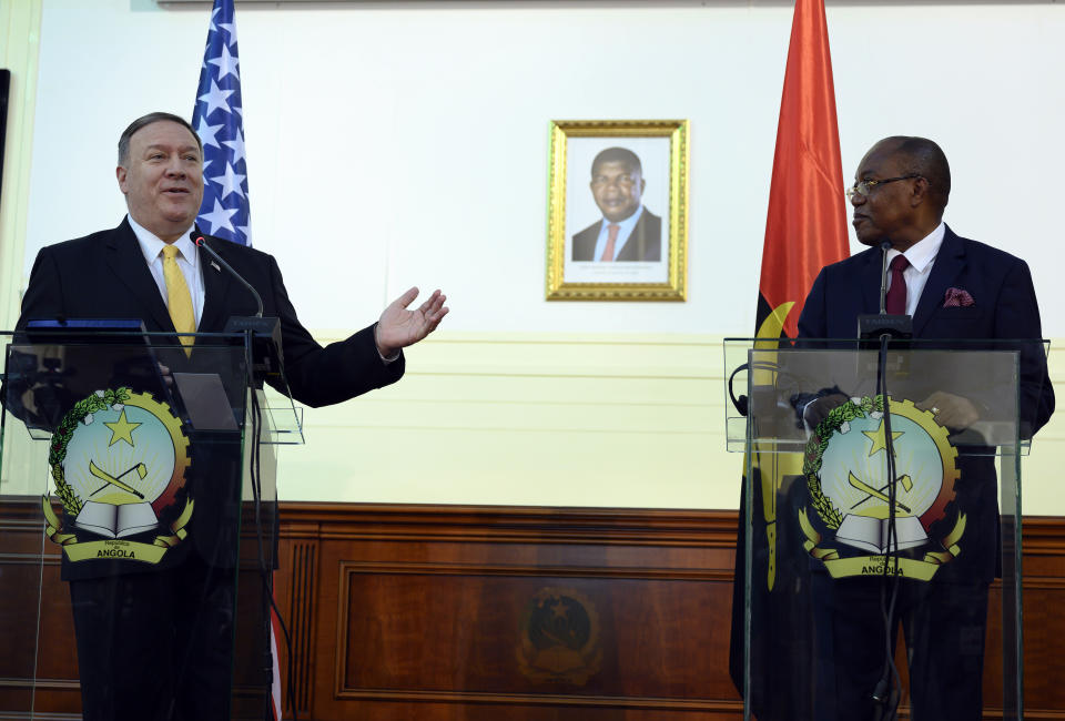 US Secretary of State, Mike Pompeo, left, and Angola Foreign Minister, Manuel Domingos Augusto hold a press conference in Luanda, Angola, Monday Feb. 17, 2020. Pompeo started his tour of Africa in Senegal, the first U.S. Cabinet official to visit in more than 18 months. He left Senegal Sunday to arrive in Angola and will then travel on to Ethiopia as the Trump administration tries to counter the growing interest of China, Russia and other global powers in Africa and its booming young population of more than 1.2 billion. (Andrew Caballero-Reynolds/Pool via AP)