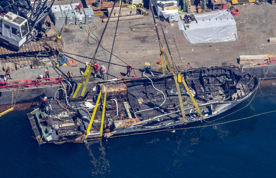 The burned hull of the Conception is brought to the surface by a salvage team, Thursday, Sept. 12, 2019, off Santa Cruz Island, Calif., in the Santa Barbara Channel in Southern California The vessel burned and sank on Sept. 2, taking the lives of 34 people aboard. Five survived. (Brian van der Brug/Los Angeles Times via AP)