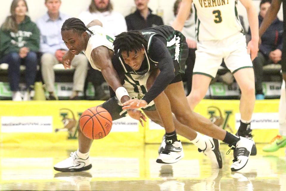 Binghamton's Christian Hinckson and Vermont's Ileri Ayo-Faleye dive for a loose ball during the Bearcats 79-57 loss to the Catamounts in the America East semifinals on Tuesday night at Patrick Gym.