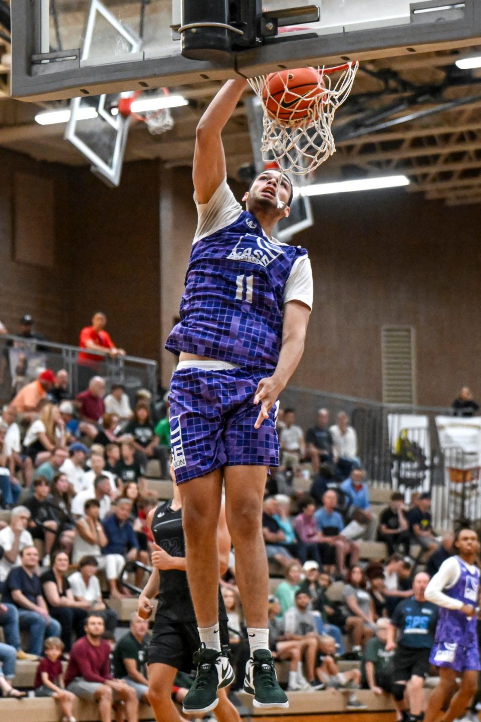 Team Case Credit Union and Michigan State's Jesse McCulloch score against Team Motorcars in game on Thursday, July 18, 2024, during the Moneyball Pro-Am at Holt High School.