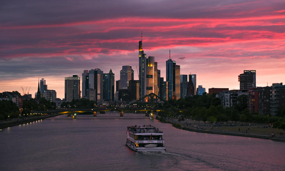 10 July 2020, Hessen, Frankfurt/Main: At sunset, a party ship sails along the Main River on the level of Frankfurt's eastern harbour towards the skyline of the banking city. Photo: Arne Dedert/dpa (Photo by Arne Dedert/picture alliance via Getty Images)