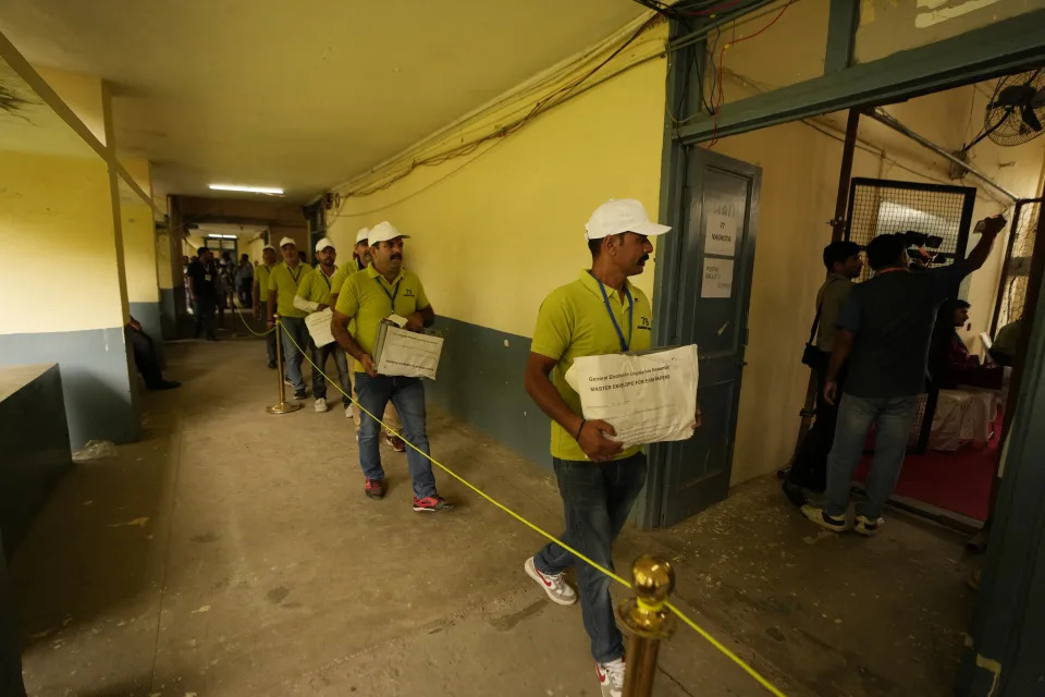 Election officials carry electronic voting machines at a counting center for the recent election in Jammu, in Jammu, India, Tuesday, Oct. 8,2024. (AP Photo/Channi Anand)