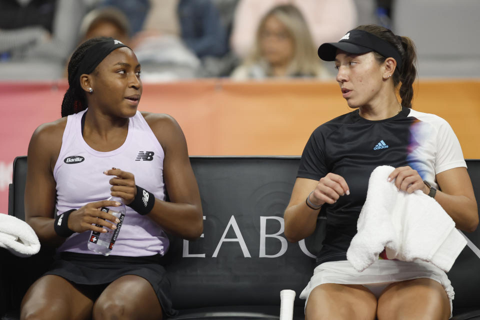 Coco Gauff, left, and Jessica Pegula, right, talk during a break in their doubles match against Yifan Xu and Zhaoxuan Yang in the WTA Finals tennis tournament in Fort Worth, Texas, Monday, Oct. 31, 2022. (AP Photo/Tim Heitman)