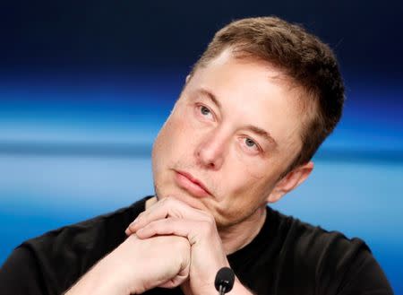 Elon Musk listens at a press conference following the first launch of a SpaceX Falcon Heavy rocket at the Kennedy Space Center in Cape Canaveral, Florida, U.S., February 6, 2018. REUTERS/Joe Skipper/Files