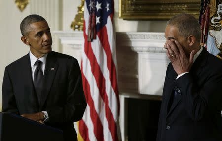 Attorney General Eric Holder wipes tears as President Barack Obama announces Holder's resignation in the White House State Dining Room, September 25, 2014. REUTERS/Gary Cameron