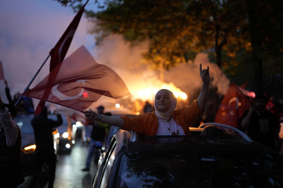 Supporters of the President Recep Tayyip Erdogan celebrate outside AK Party offices in Istanbul, Turkey, Sunday, May 28, 2023. Turkey's incumbent President Recep Tayyip Erdogan has declared victory in his country's runoff election, extending his rule into a third decade. (AP Photo/Khalil Hamra)