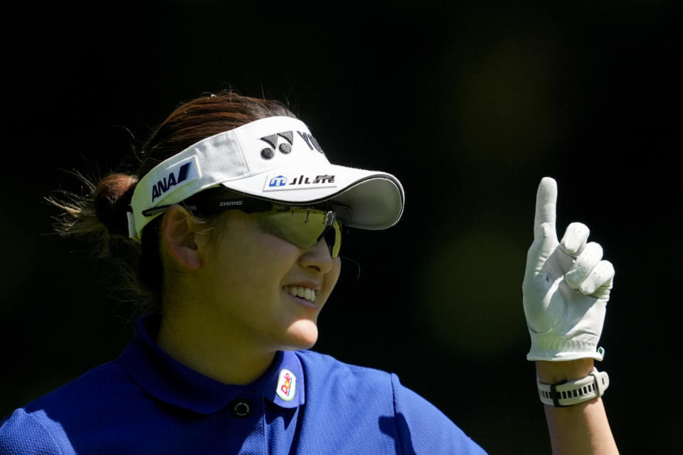 Chisato Iwai, of Japan, smiles while working on the green of the 16th hole during a practice round for the Women's PGA Championship golf tournament at Sahalee Country Club, Wednesday, June 19, 2024, in Sammamish, Wash. (AP Photo/Lindsey Wasson)