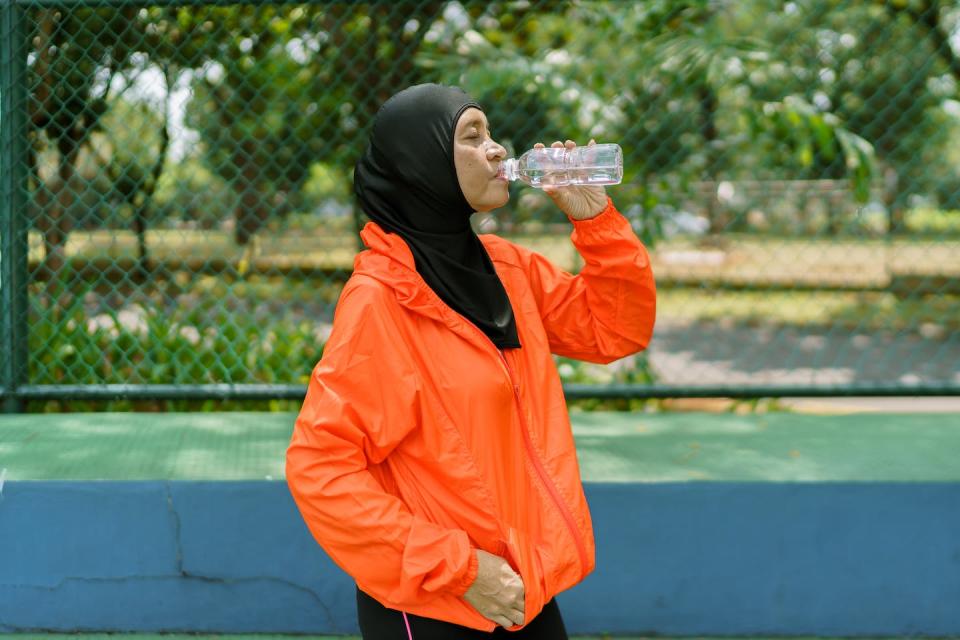 Be sure to drink up during and after your workout. <a href="https://www.gettyimages.com/detail/photo/proud-and-confident-muslim-woman-with-hijab-royalty-free-image/1062308638" rel="nofollow noopener" target="_blank" data-ylk="slk:Deby Suchaeri/Moment via Getty Images;elm:context_link;itc:0;sec:content-canvas" class="link ">Deby Suchaeri/Moment via Getty Images</a>