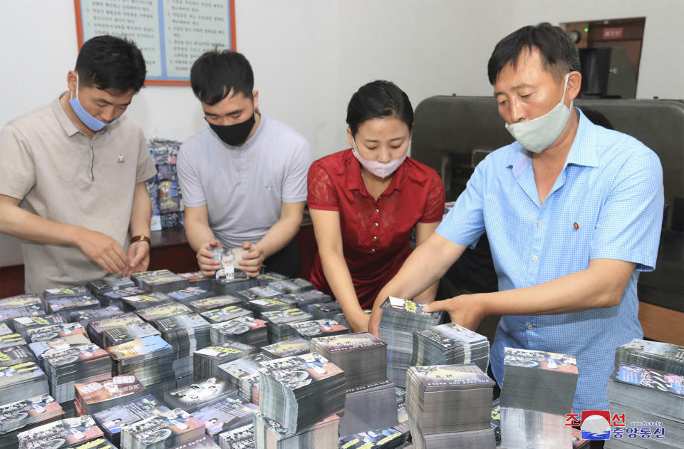 FILE - This file photo provided on June 20, 2020, by the North Korean government shows North Koreans prepare anti-South Korea propaganda leaflets in North Korea. South Korea on Monday, June 22, 2020 urged North Korea to scrap a plan to launch propaganda leaflets across the border, after the North said it’s ready to float more than 10 million leaflets in what would be the largest such physiological campaign against its southern rival. Independent journalists were not given access to cover the event depicted in this image distributed by the North Korean government. The content of this image is as provided and cannot be independently verified. (Korean Central News Agency/Korea News Service via AP, File)