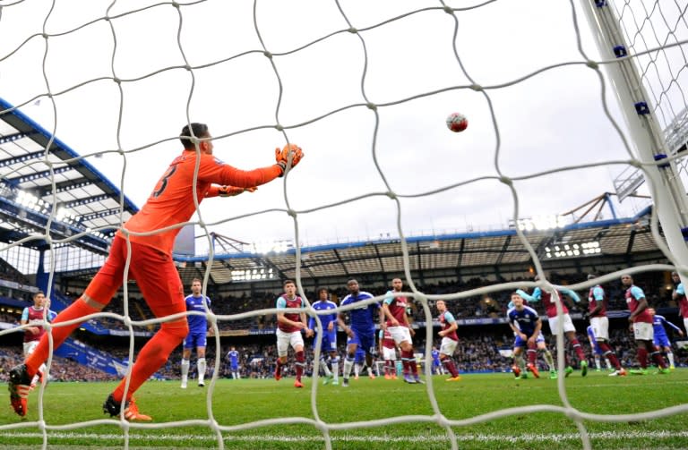 West Ham goalkeeper Adrian fails to save the freekick from Chelsea's Cesc Fabregas (2nd R) during their Premier League match at Stamford Bridge on March 19, 2016