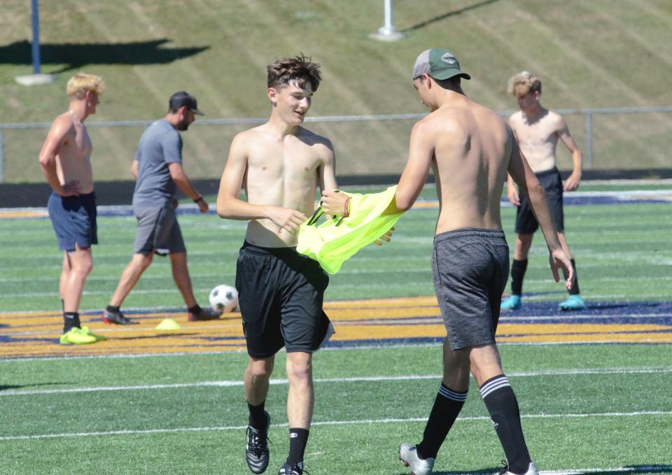 Two Gaylord players exchange pinnies during a practice on Tuesday, August 9.